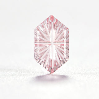 Faelight Cut lab-grown pink sapphire long hexagon 5 x 9 mm loose gemstone, concave starburst facets, on white