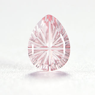 Faelight Cut lab-grown pink sapphire pear 6 x 8 mm loose gemstone, concave starburst facets, on white