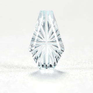 Faelight Cut natural sky blue topaz kite 7 x 10 mm loose gemstone, concave starburst facets, on white
