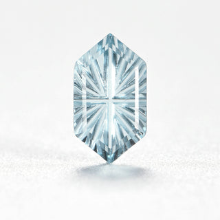 Faelight Cut natural sky blue topaz long hexagon 5 x 9 mm loose gemstone, concave starburst facets, on white