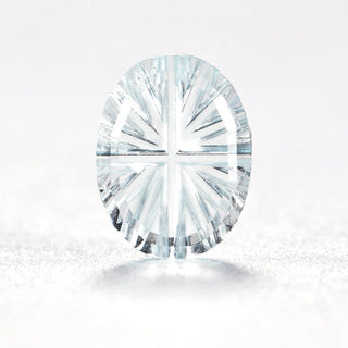 Faelight Cut natural sky blue topaz oval 6 x 8 mm loose gemstone, concave starburst facets, on white