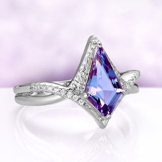 Angled view of the Faelyn alexandrite ring, showing the carved halo and the row of cubic zirconia sweeping up the crossover band