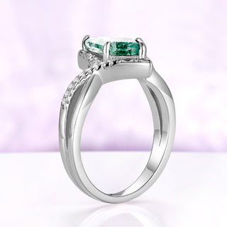 Side profile of the Faelyn moss agate ring in sterling silver, the two strands of the band crossing below the kite setting