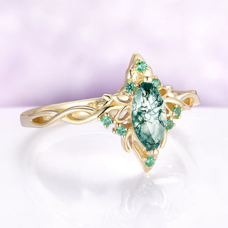 Gold ring with a green gemstone on a light purple background