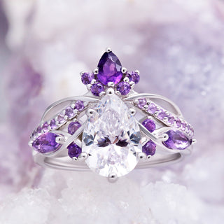 Feyra Natural Amethyst & Simulated Diamond Engagement Ring by Aquamarise, a pear-cut simulated diamond with amethyst marquise accents on amethyst crystals.