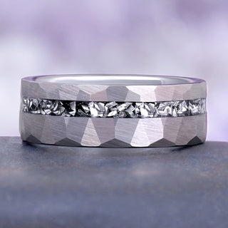 Galaxy Meteorite Men's Wedding Band in Silver Tungsten Carbide (8mm) by Aquamarise lying flat on blue-gray slate, the bright meteorite inlay running the full width