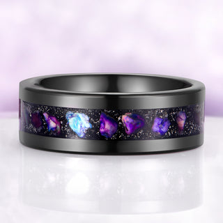 Black ring with embedded purple stones on a light purple background