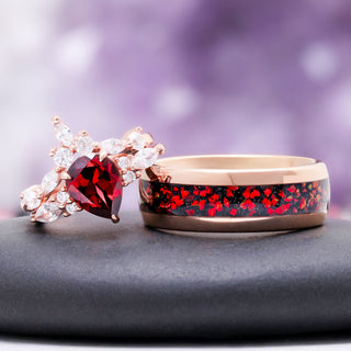 Pear cut garnet cluster ring beside the rose gold tungsten band with crushed red fire opal inlay