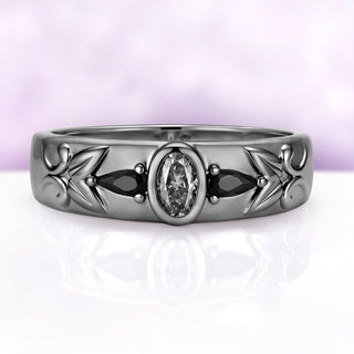 Gray Moissanite & Black Onyx Wedding Band in Black Ruthenium (6mm) by Aquamarise, bezel-set oval gray moissanite between two pear black onyx with carved leaf shoulders
