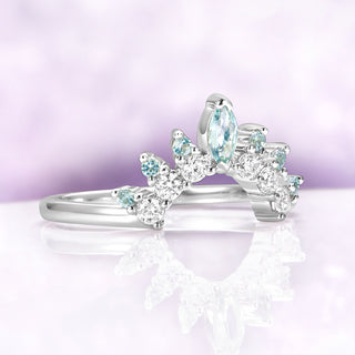 Green Sapphire Marquise Tiara Contour Ring in Sterling Silver by Aquamarise, featuring marquise and round sapphires with a tiara-inspired curve on a reflective surface.