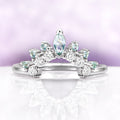 Green Sapphire Marquise Tiara Contour Ring in Sterling Silver by Aquamarise, featuring marquise and round stones with a delicate tiara-inspired design on a reflective white surface.