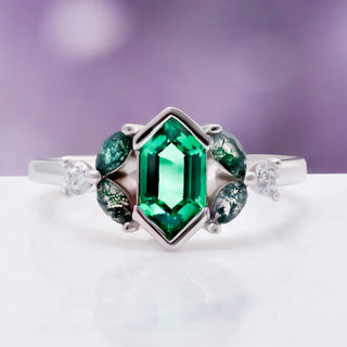 Close-up of the hexagonal emerald center stone with moss agate accents