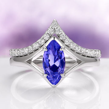 Natural Tanzanite Chevron Ring Set in 14K White Gold (two-piece) by Aquamarise Gold featuring a marquise-cut violet-blue tanzanite gemstone framed by a chevron-shaped band adorned with sparkling white diamonds, part of Solid Gold Engagement Rings and December Birthstone collections.