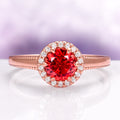 Ella Padparadscha Sapphire Ring in 14K Rose Gold Vermeil by Aquamarise, featuring a vibrant round orange sapphire surrounded by sparkling white stones in a delicate vintage-inspired setting.