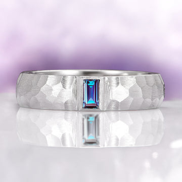 Alexandrite Hammered Wedding Band in 14K White Gold (5.5mm) by Aquamarise Gold featuring a unique hammered texture and a central emerald-cut alexandrite stone with a polished brushed finish, part of Men's and Women’s Wedding Bands collections.