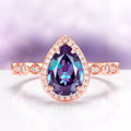 Art Deco Alexandrite Ring in 14K Rose Gold Vermeil by Aquamarise featuring a teardrop color-changing gemstone surrounded by small sparkling stones on a detailed rose gold vermeil band.