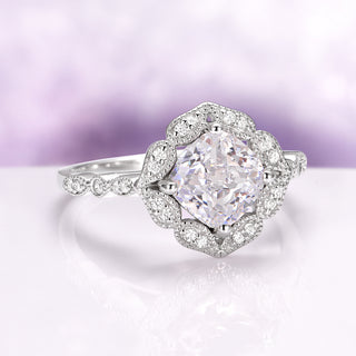 Simulated Diamond Vintage Engagement Ring in Sterling Silver by Aquamarise featuring a cushion-cut center stone with intricate vintage-inspired pavé details on a delicate band.