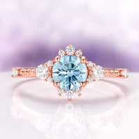 Round Cut Aquamarine Engagement Ring in 14K Solid Rose Gold featuring a vintage-inspired design with a central aquamarine surrounded by sparkling accent stones by Aquamarise Gold.