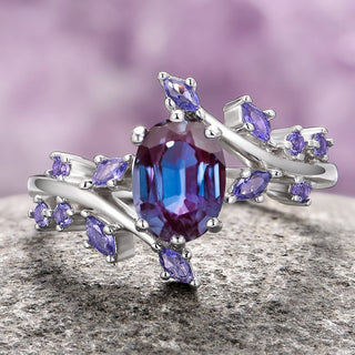 An Alexandrite & Cornflower Sapphire Fairy Leaf Ring set in 14K White Gold, with a color-changing alexandrite center stone and sparkling cornflower sapphires arranged in a leaf pattern on a textured background.