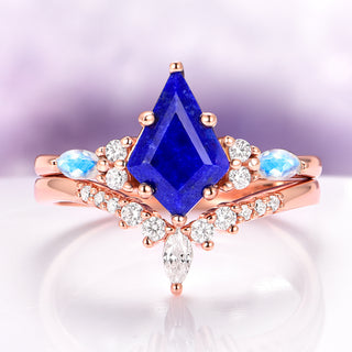 Rose gold ring with a blue gemstone and small diamonds on a light purple background