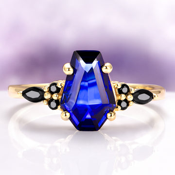 Coffin Cut Blue Sapphire and Gold Leaf Couples Ring Set featuring a vibrant blue coffin-cut sapphire with black gemstone accents in gold by Aquamarise, perfect for matching couples rings.
