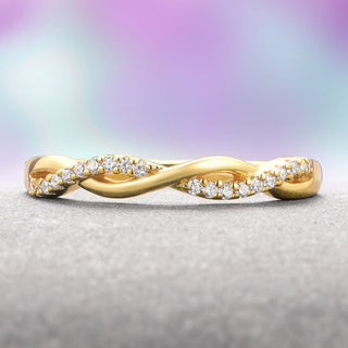 Gold ring with diamonds on a textured surface and blurred multicolored background