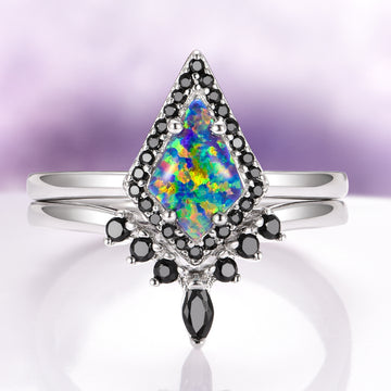 Galaxy Green Fire Opal Couples Ring Set by Aquamarise featuring a vibrant diamond-shaped green fire opal surrounded by black stones set on polished silver bands symbolizing love and unity.