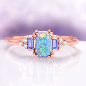 Light Blue Fire Opal & Opalescent Sapphire Couples Ring Set featuring a vibrant opal center stone, sapphire accents, and rose gold band, designed by Aquamarise for matching couples rings.