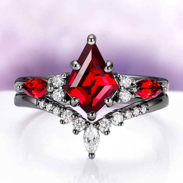 Skye Kite® Natural Red Garnet Couples Ring Set by Aquamarise featuring a striking red garnet center with pear and round white stones on black-finish bands, a bold symbol of love.