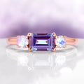 Alexandrite and Moonstone Ring in 14K Solid Rose Gold by Aquamarise Gold, featuring a rectangular alexandrite flanked by glowing moonstones on a polished rose gold band.
