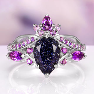 Elegant ring with purple gemstones on a reflective surface
