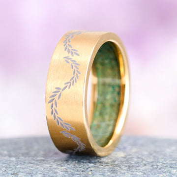 Green Moss Agate Leaf Wedding Band in Yellow Gold Titanium (8mm) by Aquamarise, featuring a brushed gold titanium exterior engraved with a delicate leaf pattern and an inner band of green moss agate, part of Men's Wedding Bands and Moss Agate Jewelry collections.