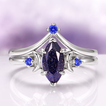 Lunar Starlight Sandstone Ring Set (Starry Night) in 14K White Gold featuring a marquise-cut blue sandstone with sparkling gold flecks, accented by vibrant blue gemstones on elegant white gold bands by Aquamarise Gold.