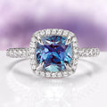 Belle Cushion Cut Alexandrite Ring in Sterling Silver by Aquamarise featuring a lab-created color-shifting alexandrite center stone with diamond accents on a 925 sterling silver band.