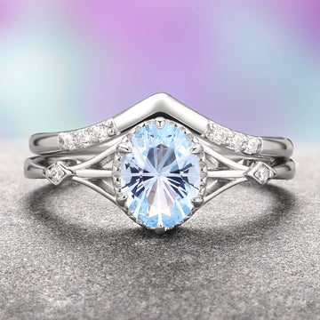 Fireworks Cut Aquamarine Couples Ring Set by Aquamarise featuring a sparkling oval aquamarine center stone with intricate silver band accents and small diamond details, part of Matching Couples' Rings and March Birthstone Jewelry collections.