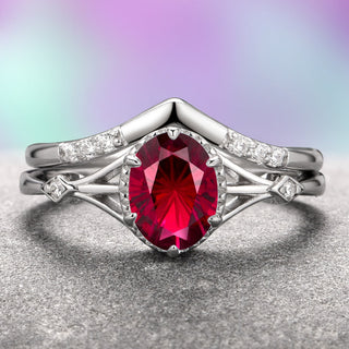 A two-piece Celtic ring set with a star-cut ruby center stone and accent stones, crafted in 14K white gold, displayed against a purple and gray background.