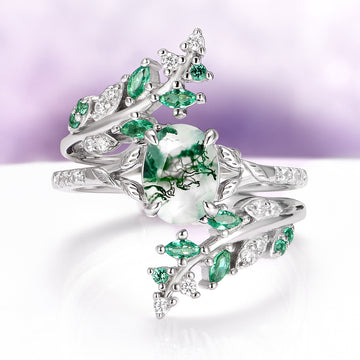 Moss Agate & Emerald Fairy Leaf Couples Ring Set by Aquamarise featuring a nature-inspired sterling silver band with a moss agate center stone, accented with emerald and sparkling clear gemstones, part of Matching Couples’ Rings and May Birthstone Jewelry collections.