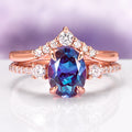 Bella Oval Cut Alexandrite Engagement Ring Set in 14K Solid Rose Gold by Aquamarise Gold featuring a deep blue-purple oval alexandrite with sparkling diamond accents on elegant rose gold bands.