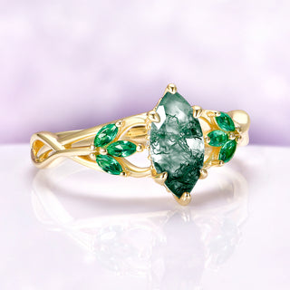 Moss Agate & Emerald Celtic Knot Ring in 14K Solid Yellow Gold by Aquamarise Gold, featuring a marquise moss agate center with emerald accents in a nature-inspired design.