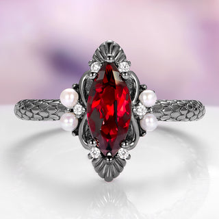 Elegant ring with a red gemstone and pearls on a soft purple background