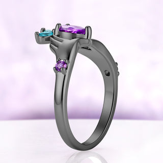 Side profile of the Claddagh engagement ring, showing how high the pear amethyst sits above the black ruthenium band