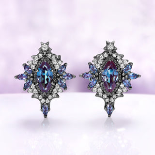 Nightbriar lab-grown alexandrite stud earrings in black ruthenium, marquise center stones in milgrain frames with alexandrite rays and a star crest