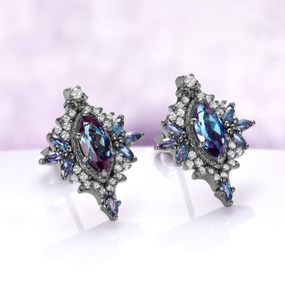 Angled view of the Nightbriar alexandrite stud earrings showing the teal-to-violet color shift, cubic zirconia halo and marquise point below the frame