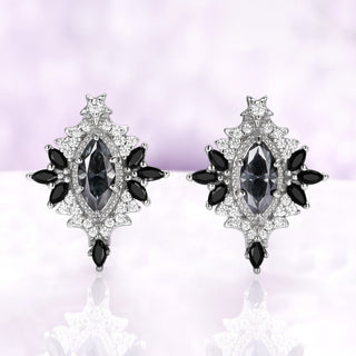 Nightbriar dark gray moissanite stud earrings in sterling silver with natural black onyx marquise rays and a star crest