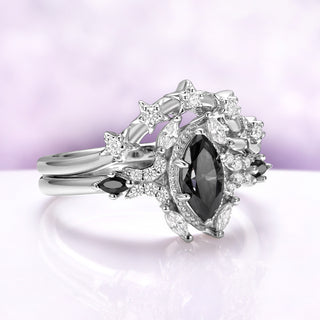Three-quarter view showing the star band settings and the dark gray moissanite center