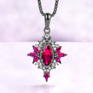 Nightbriar lab-grown ruby pendant necklace in black ruthenium, marquise center stone in a milgrain starburst frame on a box chain