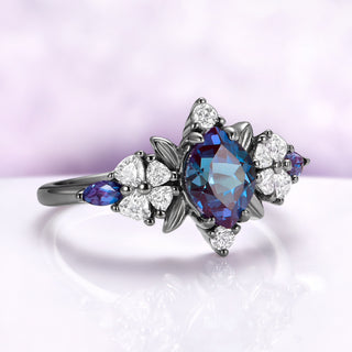 Angled view of the alexandrite center, black leaf frame and heart cut blossom shoulders