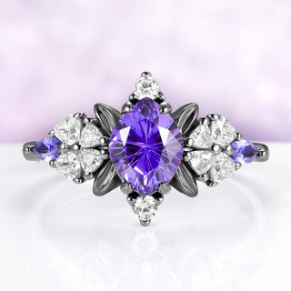 Purple sapphire engagement ring in black ruthenium with fantasy cut center and leaf frame