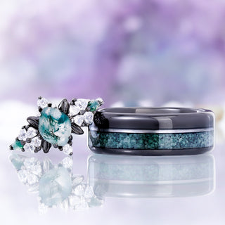 Noraleaf marquise moss agate ring in black ruthenium shown beside the matching men's off-set moss agate and black onyx tungsten band as a couples pairing