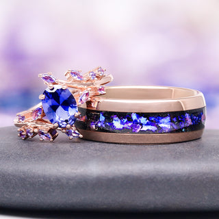 Rose gold ring with purple gemstone on a gray surface